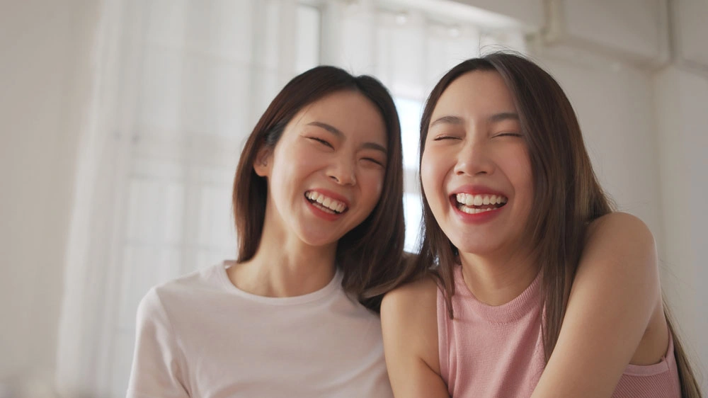 Two patients smiling and laughing together